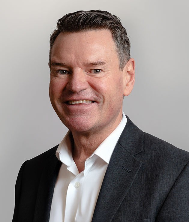 a dark haired man in a dark grey suit