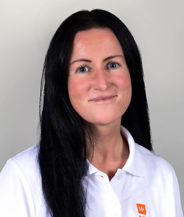 a woman with black hair in a white shirt smiling