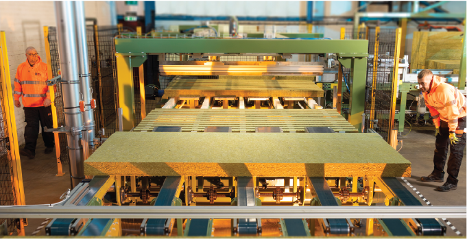 Isoclad production operatives monitoring mineral wool core moving through the manufacturing line.