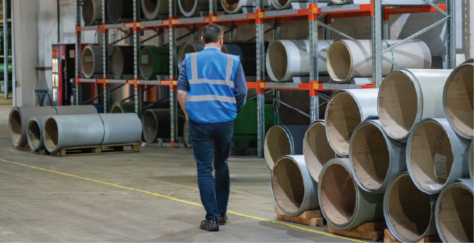 Isoclad team member walking through the steel coil storage area.