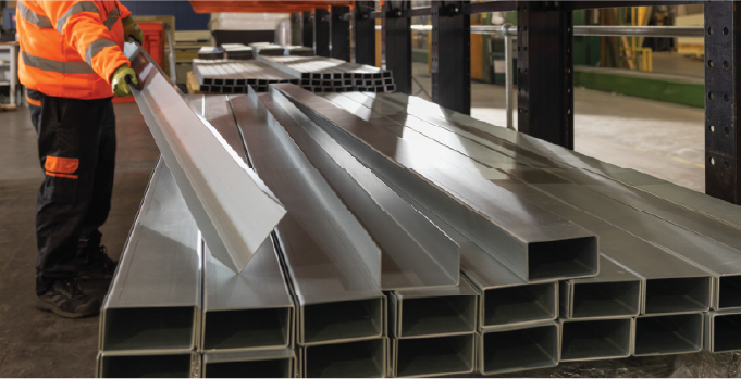 Isoclad production operative handling finished metal flashings and trims.