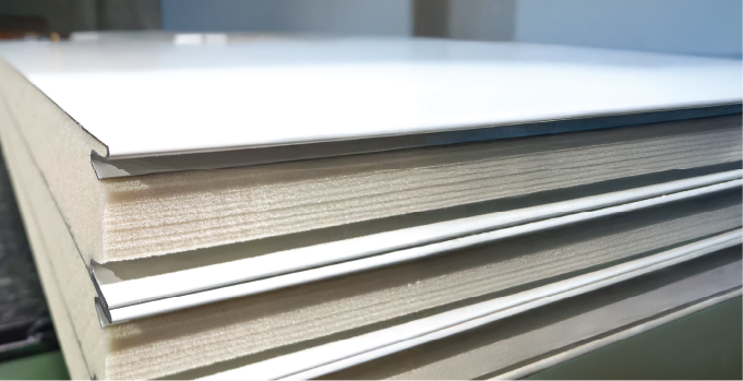 Close-up of stacked insulated panels showing the interlocking joint profile.