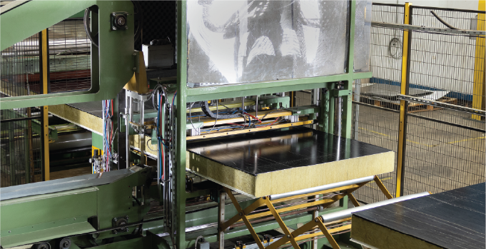 Insulated panel moving through cutting equipment on the Isoclad production line.